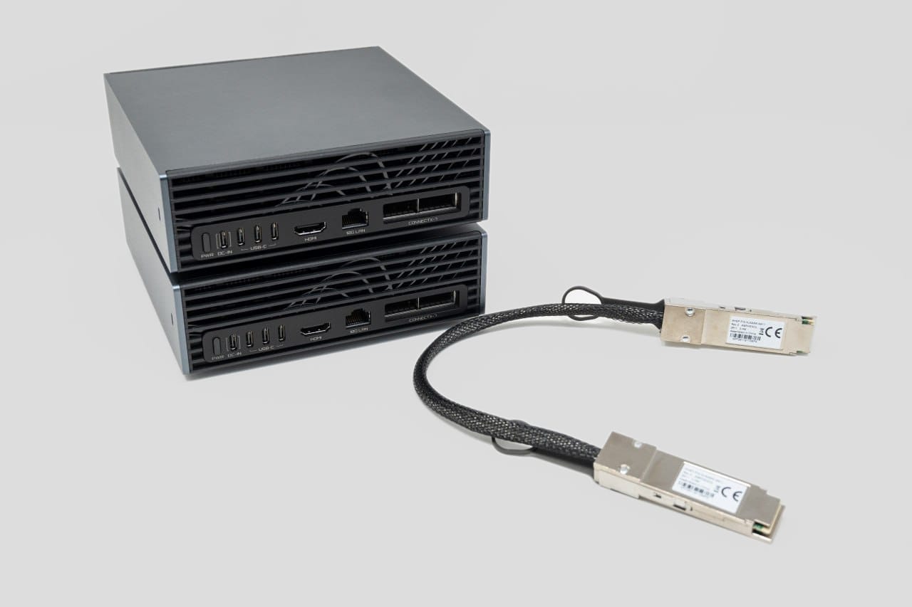 Two GIGABYTE AI TOP ATOM systems beside the full direct-attach cable