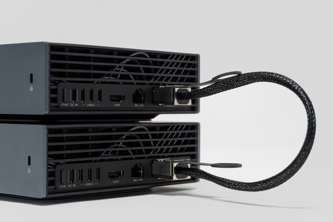 Rear view of two GIGABYTE AI TOP ATOM systems linked by one looped direct-attach cable